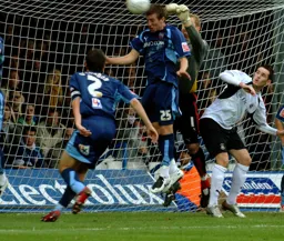 David Bell watches on as the Brentford defence clears