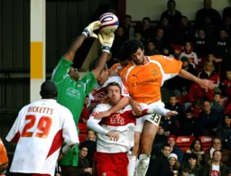 Marc Wilson goes for a header