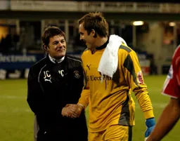 John Carver and Dean Brill shake hands