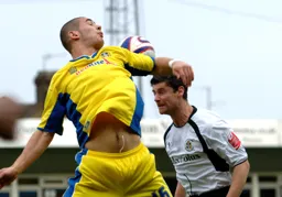 Steve Robinson tries to win the header