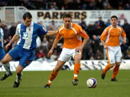 Sol Davis on the ball with Steve Robinson watching on
