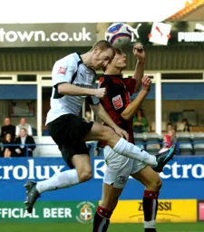 Drew Talbot heads the ball over