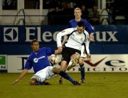 Matthew Spring gets his pass away despite the efforts of the Millwall player