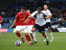 Ryan Charles battling for the ball with Sam Parkin watchig on