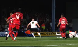 Micky Spillane (on floor) guides in the Town's first goal