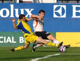 Chris Martin tries to get a cross in