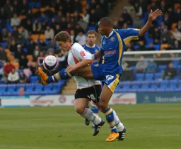 Paul McVeigh about to suffer a high boot