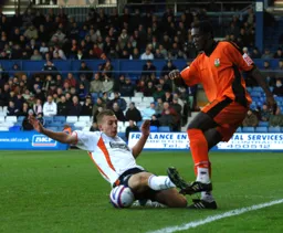 Jake Howells puts in a tackle on former Hatter Cliff Akurang