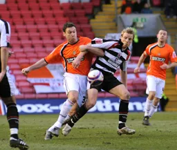 Kevin Gallen fights off a Darlington defender