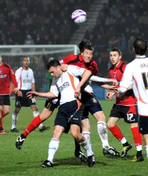 Sol Davis is beaten to the ball by Steve Fletcher