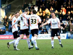 Asa Hall is mobbed after netting the third goal