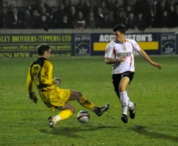 Tom Craddock tries to nick the ball past the goalkeeper