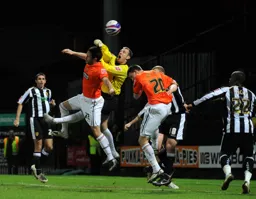 Notts keeper Kevin Pilkington punches the ball clear