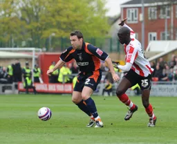 Kevin Gallen looks to lay the ball off