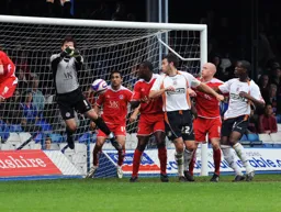 Chesterfield goalkeeper Tommy Lee punches the ball clear