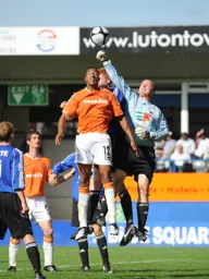 Jin Provett punches the ball away from the head of Shane Blackett