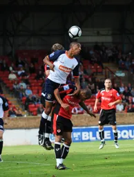 Shane Blackett heads the ball clear