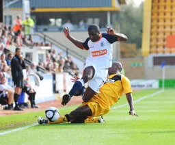 Former Town loanee Courtney Pitt puts in a sliding tackle on Adam Newton