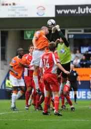 Danny Alcock punches the ball away from Alan White