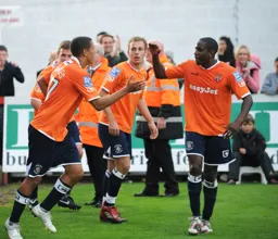 Ryan Charles has just scored Town`s last minute winner. Adam Newton joins in with the celebrations
