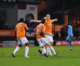 Asa Hall celebrates his goal with Adam Newton and Tom Craddock