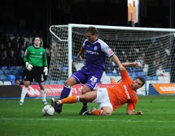 Kevin Gallen goes to ground under the challenge of Craig Dawson