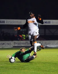 Adam Newton leaps over Histon keeper Danny Naisbitt