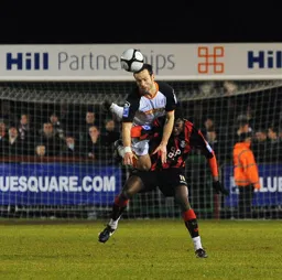 Fred Murray goes horizontal to head the ball clear