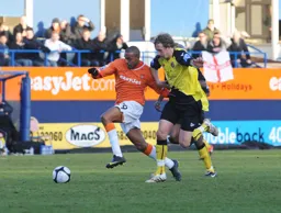 Matthew Barnes-Homer holds off a defender