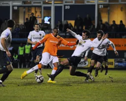A lunging tackle looks to halt Matthew Barnes-Homer