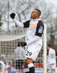Matthew Barnes-Homer celebrates in front of the travelling Hatters supporters