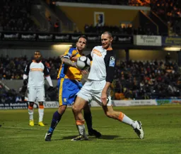 Liam Hatch fights for the ball with Luke Foster