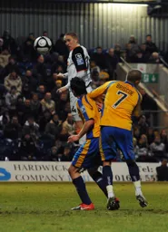 Asa Hall rises highest in the Mansfield penalty area