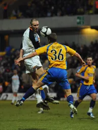 Liam Hatch gets above Mick Brough to head the ball goalwards