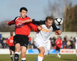 Jake Howells heads the ball forward
