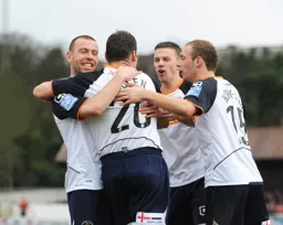Keith Keane, Tom Craddock, Jake Howells celebrate with Kevin Gallen after his goal