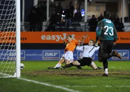 Simon Heslop slides in to score the fourth goal