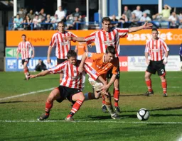 Tom Craddock tussles for the ball
