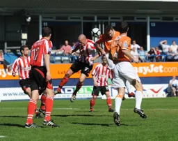 Kevin Gallen wins a header