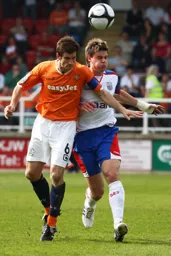 George Pilkington heads the ball clear