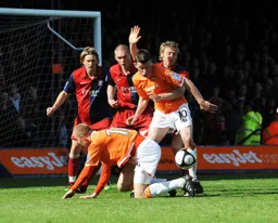 Asa Hall and Tom Craddock fight for the ball in the York penalty area