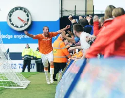 Andy Drury celebrates with the fans in the Kenilworth Road end