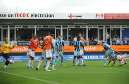 George Pilkington, falling on the right of the photo, steers the ball goalwards for the Town's second goal