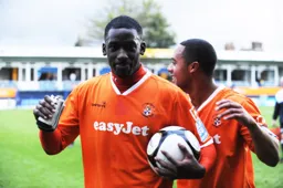 Amari Morgan-Smith celebrates his hat-trick with the match ball