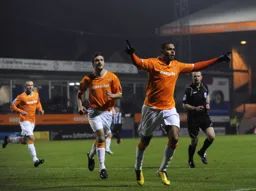 Matthew Barnes-Homer celebrates scoring the Hatters opening goal