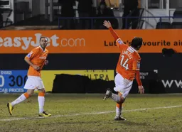 Alex Lawless wheels away in full Easyjet mode as he added the fourth goal for the Hatters