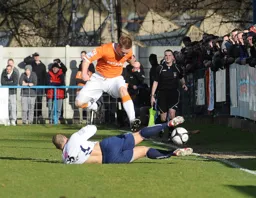 Jason Walker hurdles the Guiseley defender