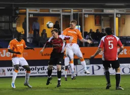 Jason Walker puts in a powerful header that has Morgan-Smith flinching