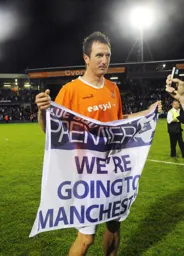 Zdenek Kroca with the unusual 'We are going to Manchester' banner