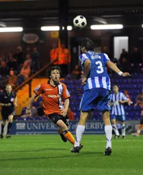 Euan Holden heads clear from the on russhing John-Paul Kissock